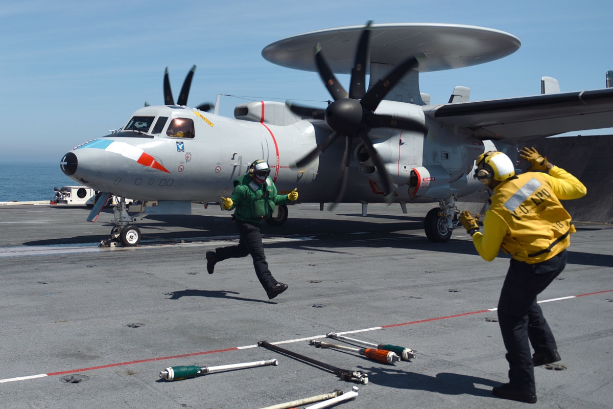 Catapult officer Nigel (R) gestures as a French Navy Hawkeye surveillance plane is catapulted off the USS George H.W. Bush aircraft carrier on May 11, 2018 in the Atlantic Ocean.