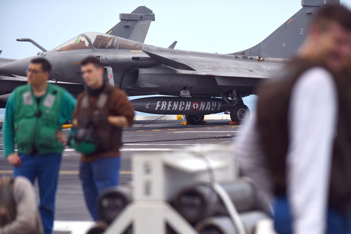 French Navy personnel chat on the deck of the USS George H.W. Bush aircraft carrier on May 12, 2018 in the Atlantic Ocean.