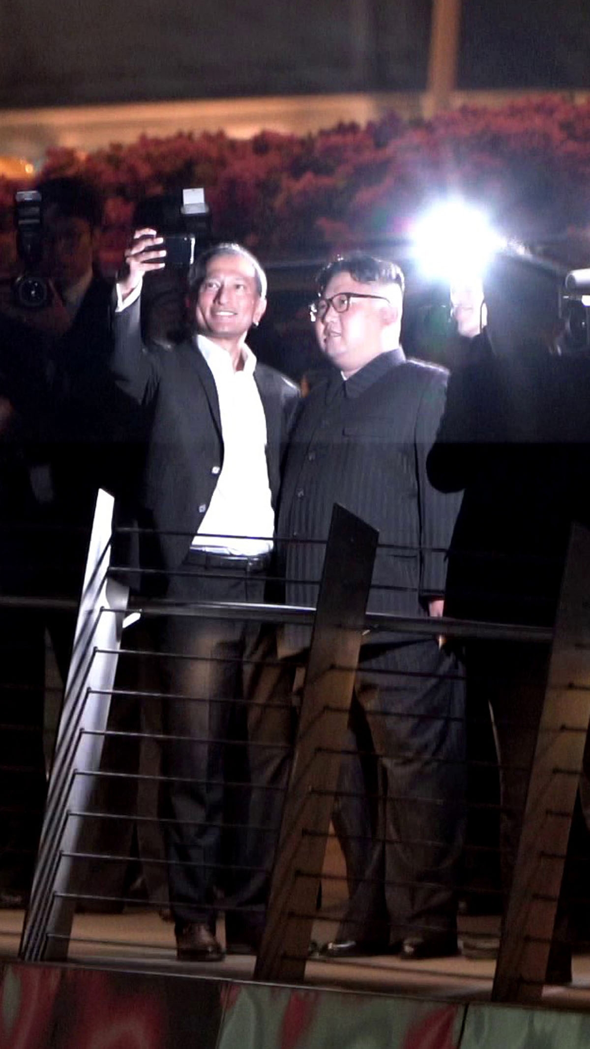 Ahead of the summit -- Singapore Foreign Minister Vivian Balakrishnan (left) takes a selfie with Kim Jong Un the night before the summit, as the North Korean leader took a stroll around some of the city-state's sights.