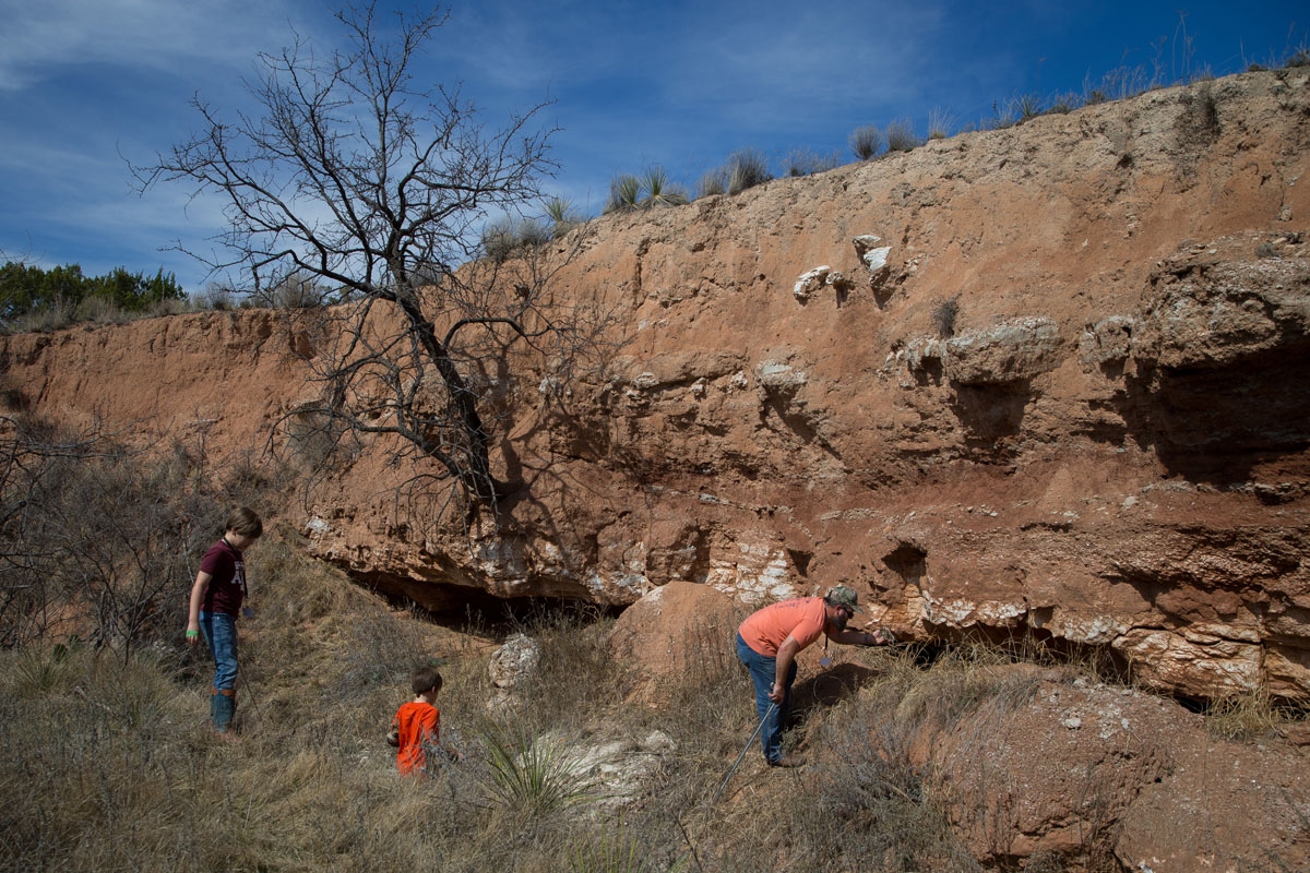 Jason Farmer hunts for rattlesnakes with sons Carter Farmer, 7, and JD Farmer (left), 9, during the Sweetwater Rattlesnake Roundup at Nolan County Coliseum on March 10, 2018 in Sweetwater, Texas.