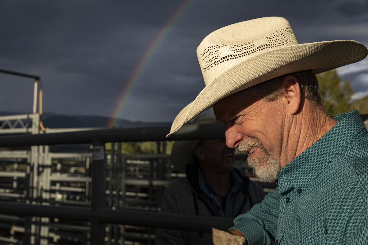 A cowboy laughs as he talks with another cowboy at the Snowmass Rodeo on August 22, 2018, in Snowmass, Colorado.