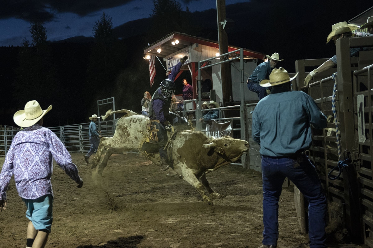 A cowboy rides a bull at the Snowmass Rodeo on August 22, 2018, in Snowmass, Colorado.