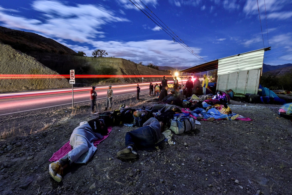 Venezuelan migrants on their way to Peru sleep along the Pan-American Highway in Ecuador, after entering the country from Colombia, August 22, 2018.