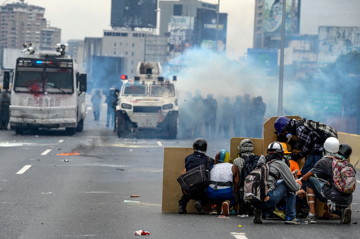 Opposition activists and riot police clash during a protest against President Nicolas Maduro, in Caracas on May 8, 2017.