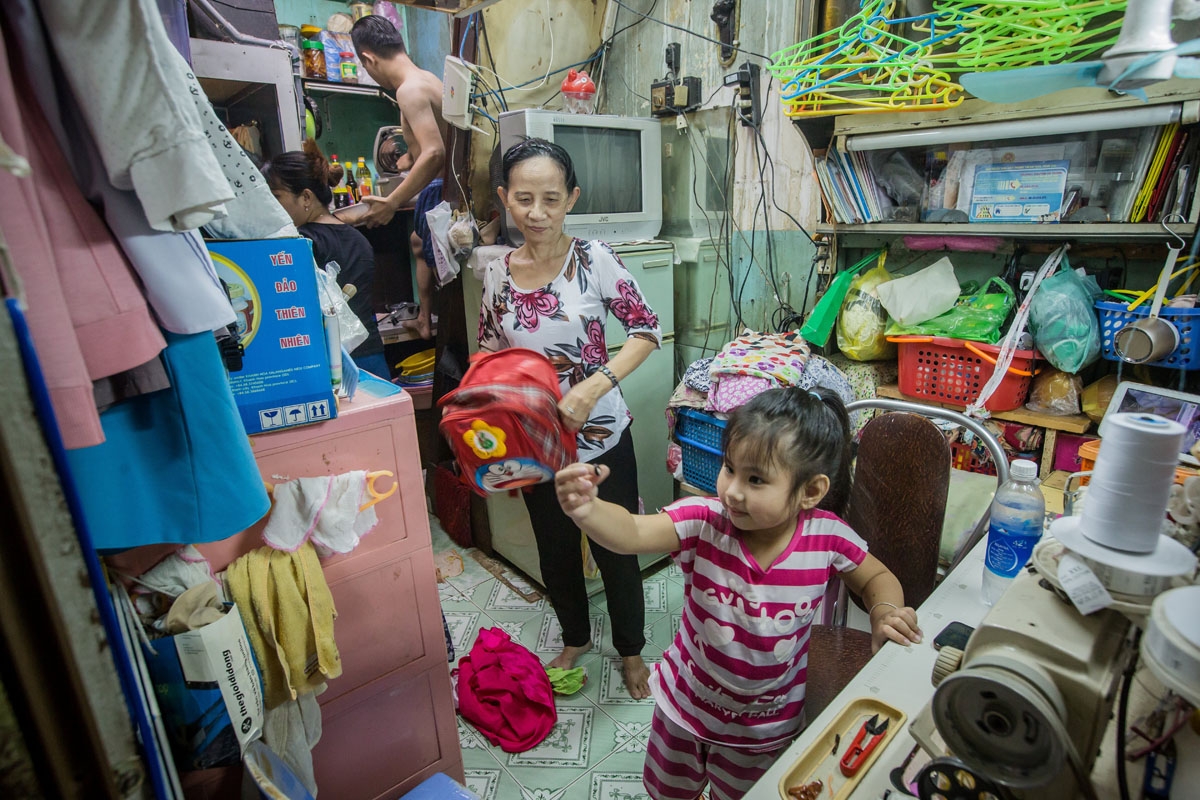 Nguyen Thi Kim Ngoc and her husband Nguyen Van Truong are seen with their granddaughter in their 6.7-square-metre home in Ho Chi Minh City on May 3, 2018.