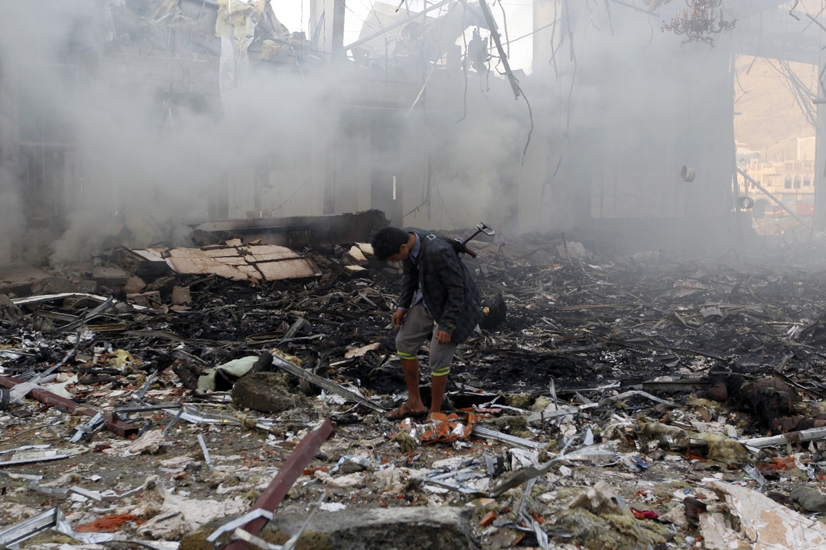 A Yemeni inspects the rubble of a destroyed building following an air strike on a funeral ceremony in the capital Sanaa on October 8, 2016.