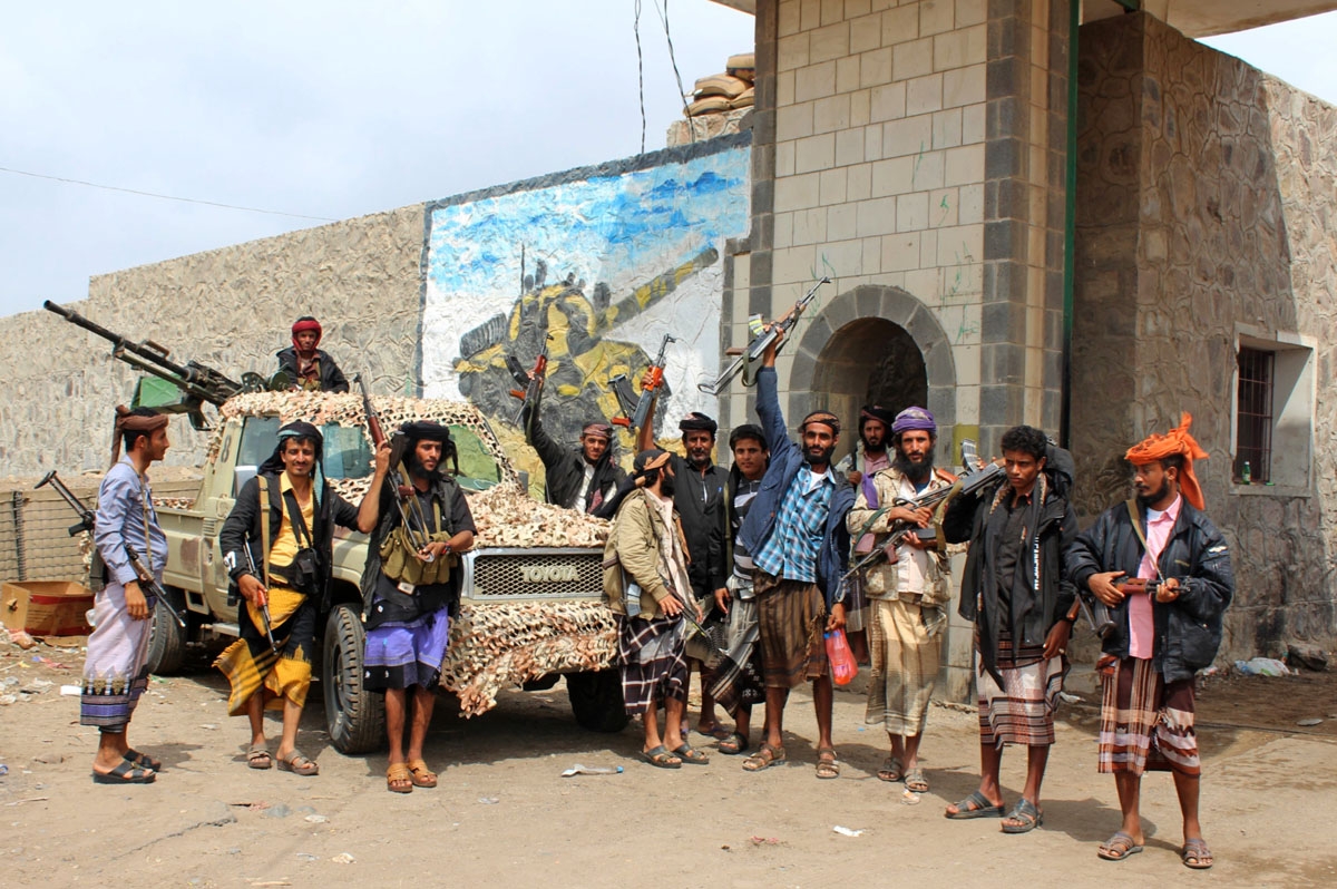 Fighters from the separatist Southern Transitional Council stand at the entrance of a military camp after they took control of the pro-government position in the Dar Saad district, in the north of Aden, on January 31, 2018