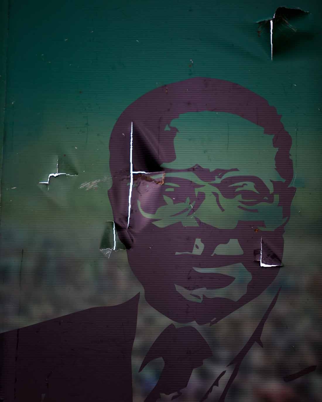 A vandalized billboard of Robert Mugabe stands in front of his party headquarters in Harare on November 19, 2017.