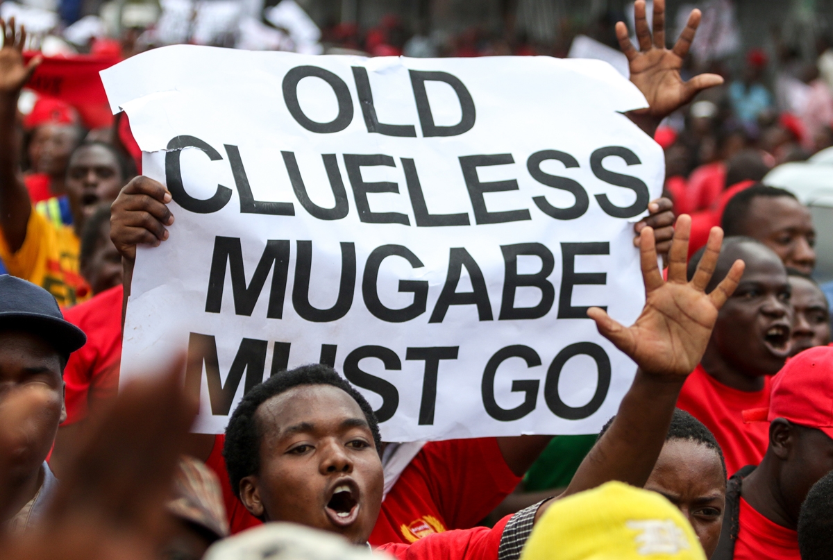 One take on things -- Movement for Democratic Change (MDC) youth supporters hold up a sign during a demonstration by the opposition party in Harare on April 14, 2016.
