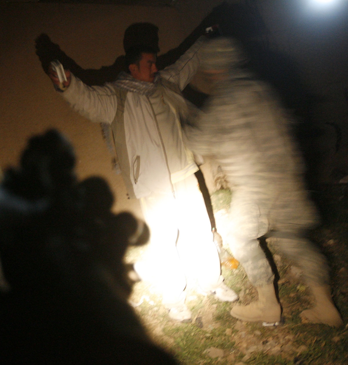 A US soldier from the 2nd Battallion 12th Field Artillery Regiment, 4-2 SBCT, frisks a man during a night patrol in the town of Baquba, 20 kms northeast of Baghdad, on February 23, 2008. T