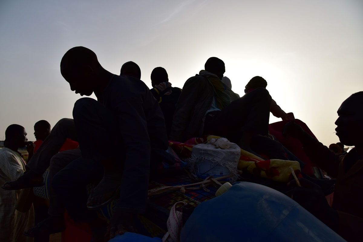 A picture taken on March 31, 2017 shows West African migrants returning from Niger after fleeing Libya due to armed groups by pickup truck in Agadez, northern Niger, following their failed attempt to reach Europe by crossing the Mediterranean Sea.
