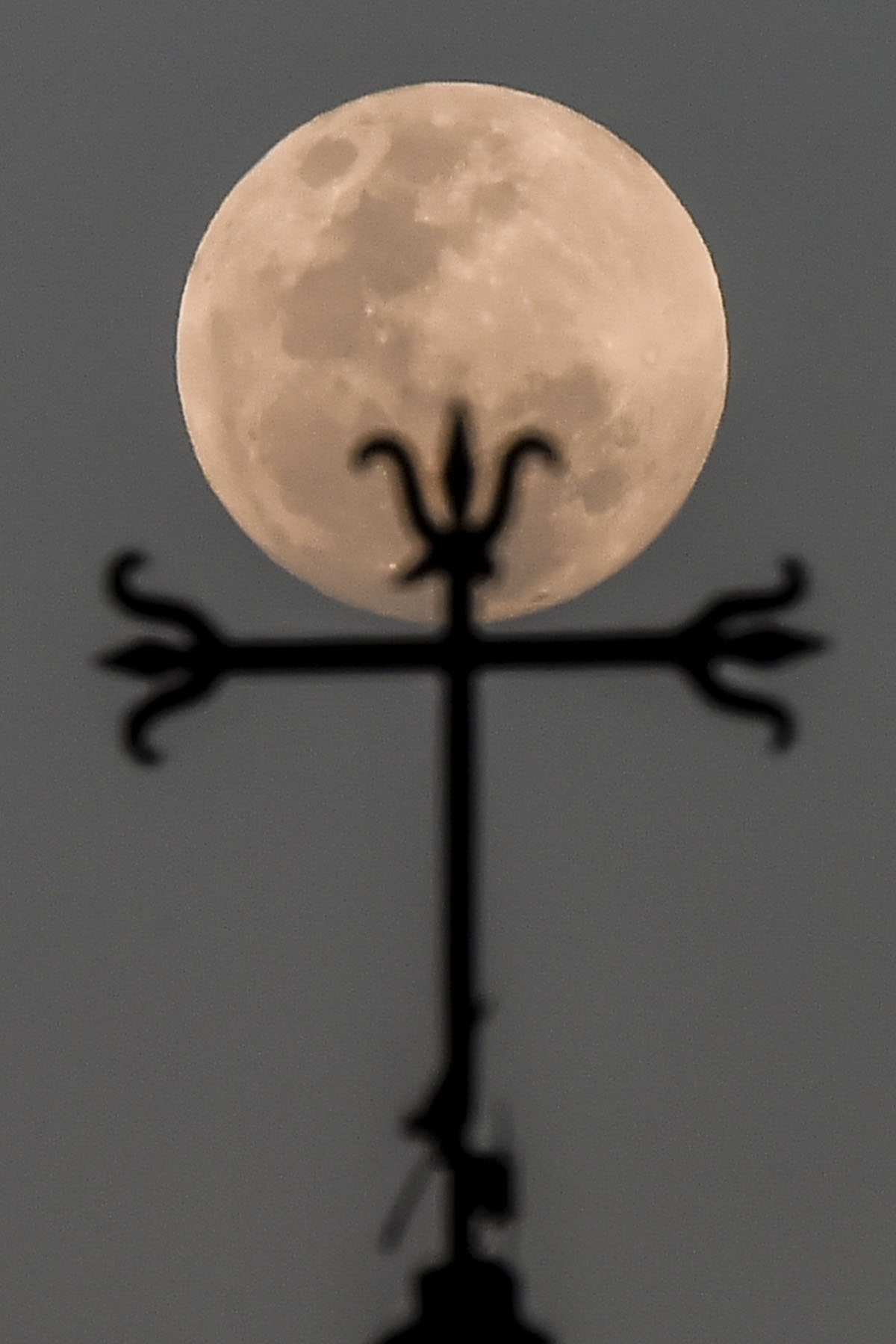 View of a full moon rising at dusk, in Cali, Colombia on January 30, 2018.