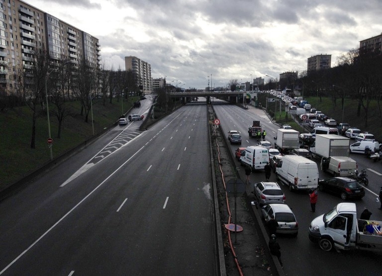 Sur le boulevard périphérique, un côté est vide, l'autre est rempli de véhicules abandonnés à la hâte Sur le boulevard périphérique, un côté est vide, l'autre est rempli de véhicules abandonnés à la hâte