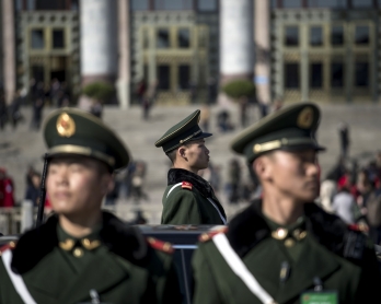Paramilitary police officers stand in front of the Great Hall of the People during the opening of the National People's Congress in Beijing on March 5, 2017.  China's rubber-stamp congress opened on March 5 in an annual pageant of Communist-controlled dem