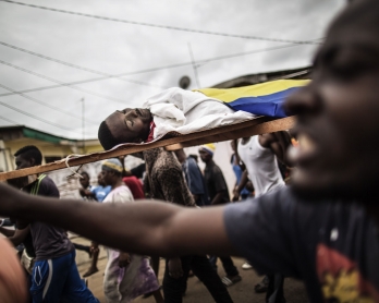 Dozens of protesters carry in a funeral procession the body of Axel Messa, 30, wrapped in the flag of Gabon, in a street of the Libreville district of Nzeng Ayong on September 2, 2016