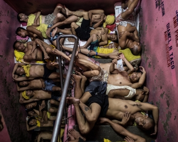 Inmates sleep on the steps of a staircase inside the Quezon City jail in Manila on July 21, 2016
