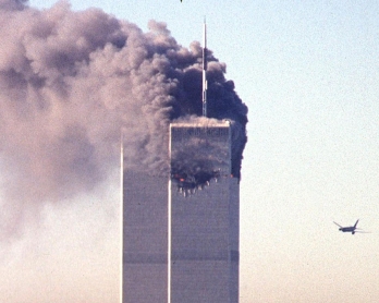 A hijacked commercial plane approaches the World Trade Center shortly before crashing into the landmark skyscraper 11 September 2001 in New York