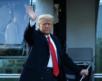 Outgoing US President Donald Trump waves as he boards Marine One at the White House in Washington, DC, on January 20, 2021. - President Trump travels his Mar-a-Lago golf club residence in Palm Beach, Florida, and will not attend the inauguration for Presi