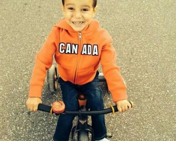 Le petit Abouzar Ahmad à Toronto le 12 mai 2014, moins de deux mois après avoir survécu miraculeusement au massacre de sa famille